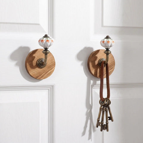 Old School Cool Antique Ceramic Wall Hooks With Rock Solid Wood Base Showstopper Entryway Coat Rack Pair on door.