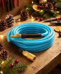 One Quarter Inch 50 Foot Polyurethane Air Hose with Brass Fittings, 300 PSI Max, coiled on a wooden bench with holiday decorations.