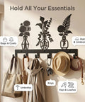 Knockout Premium Decorative Floral Metal Wall Coat Rack Featuring Six Heavy Duty Hooks And Matte Black Finish, holding bags, hats, and keys.