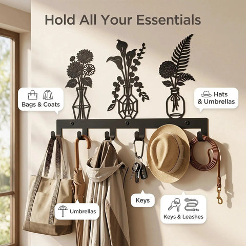 Knockout Premium Decorative Floral Metal Wall Coat Rack Featuring Six Heavy Duty Hooks And Matte Black Finish, holding bags, hats, and keys.