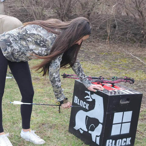 Woman with bow using Two-Sided High Velocity Archery Bag Target For Practice Up To 425 FPS Compact 28x28x12 Inch Size