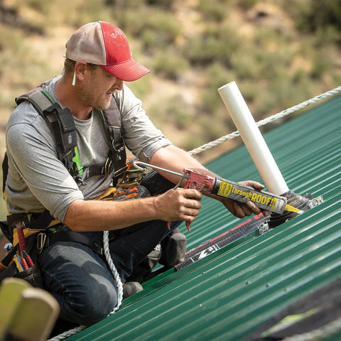 Worker applying All Weather Clear Roof Sealant 10.5 Oz Cartridge Pack Of Twelve Waterproof Leak Stopper on metal roof.