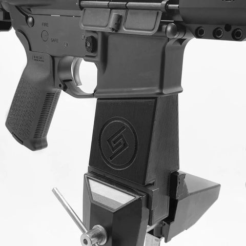Custom Rifle Vise Block for Gun Cleaning Stations and Safe Rooms, Go-To Heavy Duty Horizontal Clamp Mounts for Quick Rifle Maintenance, Made in USA, Fits Various Rifles, Durable Plastic Vise Block for Home Gun Safe Organization. AR-style rifle clamped in black vise block for maintenance.