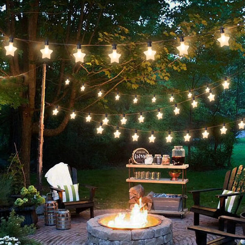 Outdoor Star String Lights Waterproof 32 Ft LED Dope Twinkle Lights 10 Stars Connectable shining above a patio with trees.