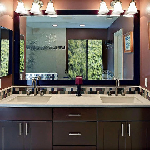 Bathroom vanity with brushed nickel cabinet pulls, dual sinks, and euro-style fixtures