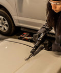 Person using Long Barrel Air Hammer For Heavy Duty Demolition And Workshop Use, 2300 Blows Per Minute on a vehicle door.
