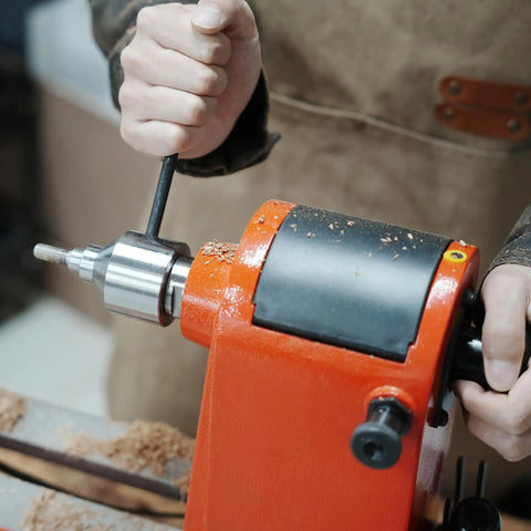 Craftsman using a Bottle Stopper Chuck For Lathe Mounting Three Eighths Inch By Sixteen TPI Stoppers And One Inch By Eight TPI Headstock