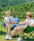 Couple sitting outdoors on Heavy Duty Portable Camping Chair With 350 Lb Capacity, Extra Wide 1.6 Inch Padded Ergonomic Seat