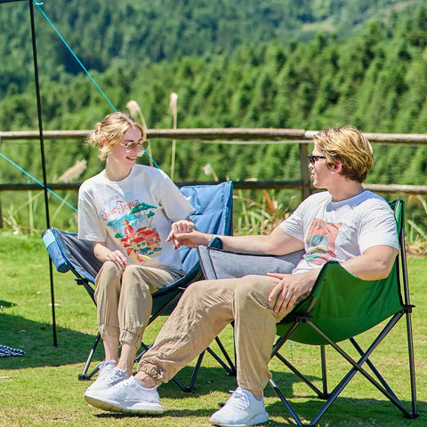 Couple sitting outdoors on Heavy Duty Portable Camping Chair With 350 Lb Capacity, Extra Wide 1.6 Inch Padded Ergonomic Seat
