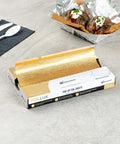 Gold Embossed Pop-Up Foil Sheets 10.8 X 9 Inch Interfolded Greaseproof and Freezable Oven Ready Aluminum Foil Papers on a table