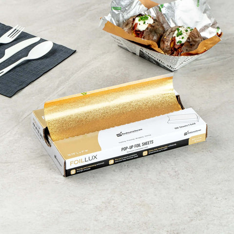 Gold Embossed Pop-Up Foil Sheets 10.8 X 9 Inch Interfolded Greaseproof and Freezable Oven Ready Aluminum Foil Papers on a table