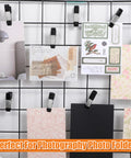 2-Inch Heavy-Duty Metal Spring Clamps Set with Non-Slip Rubber Tips holding various cards on a wire grid, ideal for photo backdrops