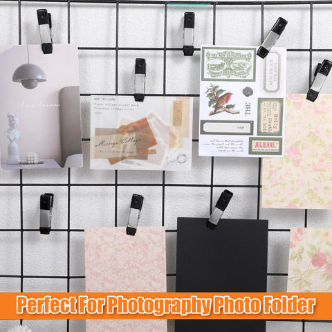 2-Inch Heavy-Duty Metal Spring Clamps Set with Non-Slip Rubber Tips holding various cards on a wire grid, ideal for photo backdrops