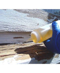 Applying LiquidWood 2 Pint Kit 2 Part Structural Epoxy Wood Hardener And Consolidant Resin to weathered wood with glove.
