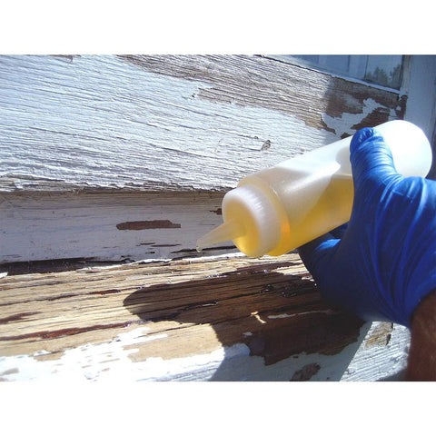 Applying LiquidWood 2 Pint Kit 2 Part Structural Epoxy Wood Hardener And Consolidant Resin to weathered wood with glove.