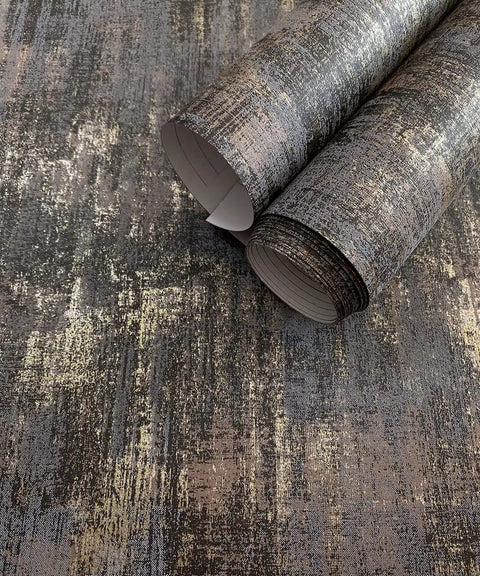 Peel And Stick Wall Covering With Industrial Textured Metallic Look In Charcoal And Gold Adhesive Distressed Wallpaper Roll About Twenty Nine Square Feet Coverage Easy Install Seventeen Point Seven Inches Wide By Two Hundred Thirty Six Inches Long showing two rolled sections on surface
