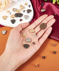 Hassle Free 15 Piece Heart Shaped Leather Rivets Kit Dope Alloy Studs And Screws in hand with coin for size reference.