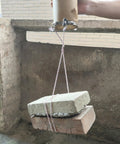 Testing the strength of a 16-Piece 304 Stainless Steel Hose Clamps Set With Adjustable Thumbscrews And T-Bolt Worm Clamp And Band Clamp Mix For 6-12mm To 38mm Hoses, lifting bricks, viewed in use.