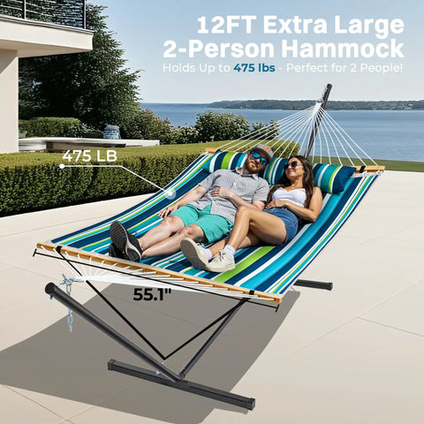 Two Person Quilted Outdoor Hammock With Stand Detachable Pillow And Bamboo Spreaders Portable Hammock With Carrying Bag Heavy Duty Frame Perfect For Yard Patio Or Outdoor Chill Dark Cyan shown in use on a patio with two people lounging