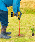 Person using Auger Drill Bit For Post Holes 32 Inch Long Garden Spiral Hole Drill For Bulb Planting, in grass with plant nearby