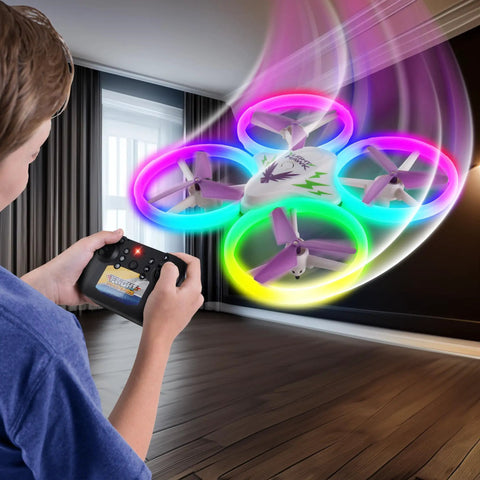 Child flying LightHawk 2.4GHz RC Quadcopter Drone with Altitude Hold, LED Light Show indoors, showing remote control use.