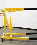 Heavy Duty Steel Engine Hoist With Telescoping Legs And Adjustable Boom Supporting 6000 Lb in use for garage lifting tasks.