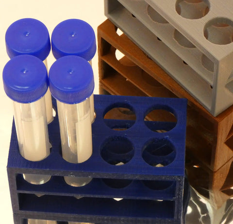 Ultra Compact Eight Position Tube Rack For 5 To 15 Milliliter Centrifuge Or Test Tubes Micro Stand Fits 18 mm Tubes And Syringes Space Saving PLA Not Autoclavable, holding test tubes with blue caps.