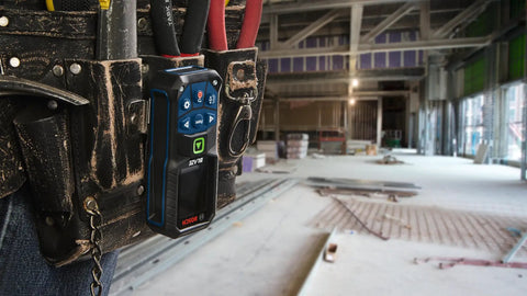 Blaze Green Beam Laser Distance Measure With 165 Foot Range And One Sixteenth Inch Accuracy on a belt in construction site