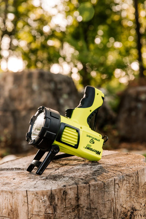 Beast Mode Rechargeable LED Spotlight For Outdoor, Marine, And Emergency Use 1400 Lumens, 400,000 Candela Peak, on tree stump