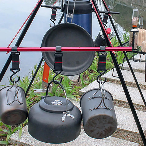 Camping gear hanging on outdoor tripod with Five Piece Large Outdoor Camping Hook Set, S Shaped Movable Strap Hooks for Quick Hanging.