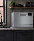 Top Shelf Compact Countertop Dishwasher Featuring Energy Star Efficiency Plus Delay Start Timer With Bright Led Interface Built Different For Small Kitchens Or Apartments To Crush Dirty Dishes Without Any Fuss In Sleek Silver on a gray countertop.