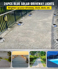24 blue solar driveway lights illuminating a curved path, showcasing solar panels and blue LED lights along the walkway.