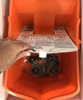 Open top view of RBC-323 Roll A Bucket With 3 Inch Caster Wheels And Brake 6 Gallon Orange Rolling Bucket with instruction manual.