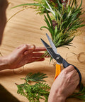 Person using All In One Garden Tool 7-In-1 Pruning Shears For Plant Care With Titanium Knife to trim branches