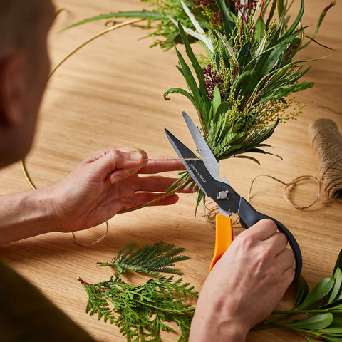 Person using All In One Garden Tool 7-In-1 Pruning Shears For Plant Care With Titanium Knife to trim branches