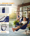 Woman relaxing in navy blue Deluxe Hanging Hammock Sky Chair For Chill Sessions With Pillow And Drink Holder on porch