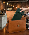 Double Layer Magnetic Signature Board With Soft Leather Cover And Built In Pen Sleeve For Restaurant Receipts And Office Signing Compact Counter Pad in a tan bag.
