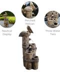 Chill Four Tier Pelican And Driftwood Outdoor Cascading Water Fountain with resin construction and pelican topper on lawn.