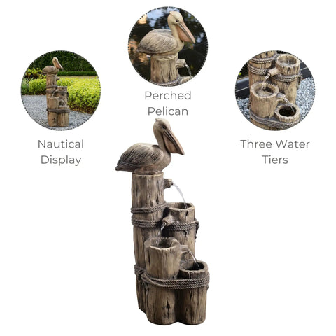 Chill Four Tier Pelican And Driftwood Outdoor Cascading Water Fountain with resin construction and pelican topper on lawn.