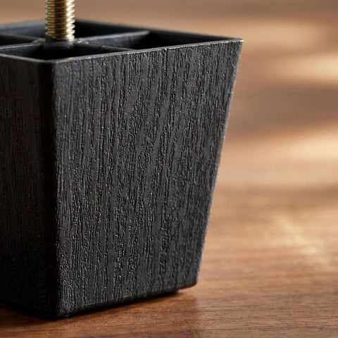 Close-up of adjustable square furniture feet with threaded studs for couches and sofas durable plastic and metal construction