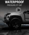 Waterproof pressure-fit cap highlighted on SUV in rain.