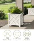 Two-Pack Lattice Outdoor Planter Boxes 15.5 Inch Square 16.5 Inch Tall White Decorative Flower Pots For Front Porch Patio Or Garden Decor Durable Outdoor Planters For Plants featuring a white lattice design with greenery. Visible out on a patio.