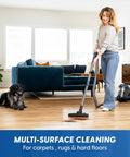 Woman using Quiet Bagless Canister Vacuum With Kickass Suction For Whole Home Cleaning Slick Tile Floors and Low Pile Carpets.