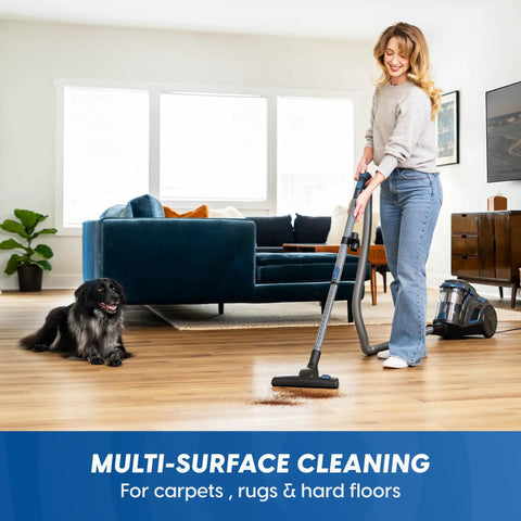Woman using Quiet Bagless Canister Vacuum With Kickass Suction For Whole Home Cleaning Slick Tile Floors and Low Pile Carpets.