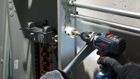 Bosch HBT225 2-1/4 in bi-metal T-slot hole saw on cordless drill drilling into metal panel