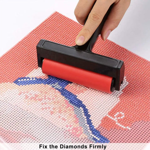 Hand using roller on diamond art canvas from All In One 22 Piece 5D Diamond Painting Tools Kit With Roller Storage Box Tweezers Pens Trays And Glue