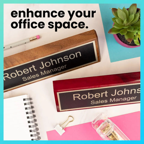 Personalized Walnut Wood Desk Name Plate With Black Base And Gold Lettering, 2 By 8 Inches, on a desk beside a plant and stationery.