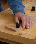 Person using 2 Inch Aluminum Round Bench Dogs With Beefy Side Spring For Thin Benchtops And Woodworking Tools Easy Height Adjustment Fits Three Quarter Inch Holes Durable Workbench Accessories on wooden surface