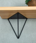 Rock Solid Heavy Duty Shelf Brackets In Matte Black Cast Iron Triangle Wall Mount Supports with wooden shelf.