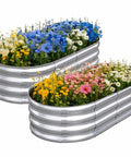 Two galvanized raised garden bed kit 4By2By1Ft oval planter boxes with colorful flowers for outdoor garden use